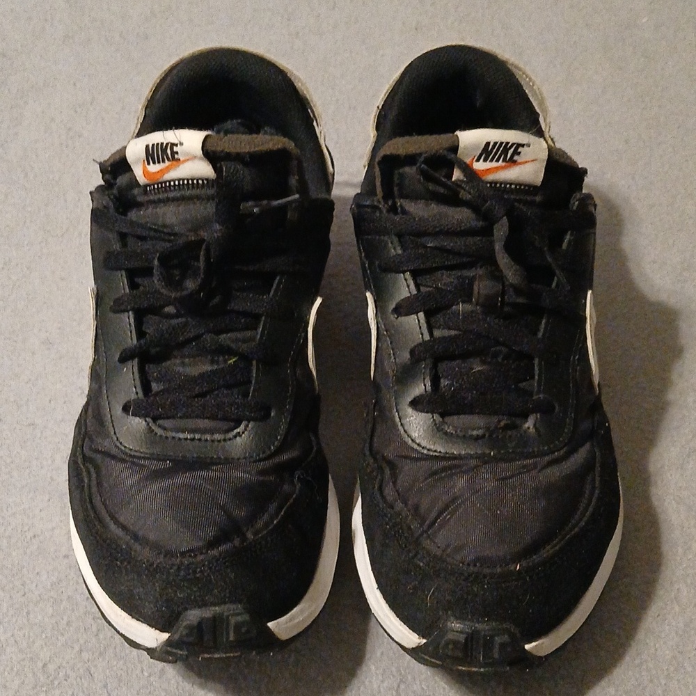 Nike Black Sneakers with White Midsoles and Orange Swoosh